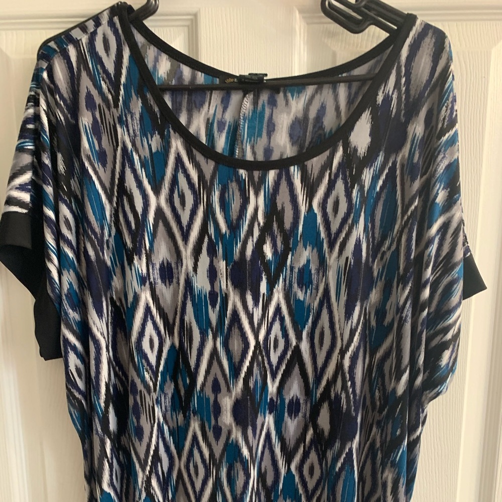 Blouse with grey, blue and black design.